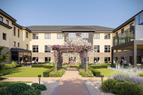 A modern three-story building with a landscaped courtyard featuring a pergola covered in flowering vines, manicured lawns, and various plants. People are seated at tables enjoying the outdoor space.
